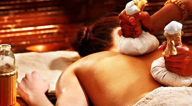 Herbal Podi Kizhi therapy using warm Ayurvedic boluses